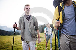 Travel, tourism, hike, gesture and people concept - group of smiling friends with backpacks