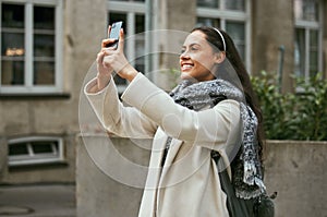Travel, tourism and phone with a woman in the city taking a photograph while traveling on holiday or vacation. Tourist