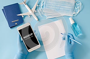 Travel and Tourism Planning after Coronavirus and Quarantine. Hands in disposable gloves hold smartphone