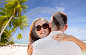 Happy couple hugging over tropical beach