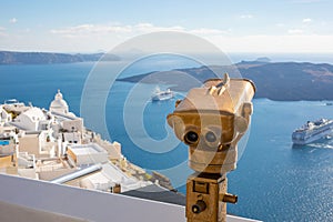 Travel tourist scene in Europe holiday walking in Santorini city street looking through tower viewers coin machine, binoculars