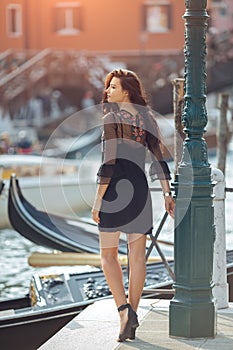 Travel tourist woman on pier against beautiful view on venetian chanal in Venice, Italy.
