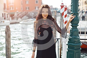 Travel tourist woman on pier against beautiful view on venetian chanal in Venice, Italy.