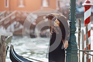 Travel tourist woman on pier against beautiful view on venetian chanal in Venice, Italy.