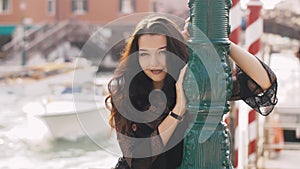 Travel tourist woman on pier against beautiful view on venetian chanal in Venice, Italy.