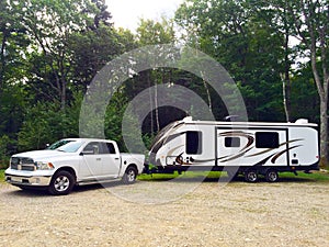 Travel trailer with white pick up truck rest