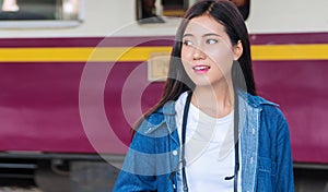 Travel transport concept. traveler girl standing on platform of railway station. Hipster young woman waiting train