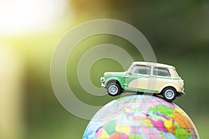 Travel and transport concept. Toy car on world map balloon