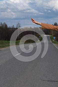 Travel, travel, leisure, passion for travel. Hitchhiker sign on the road. Thumbs up female hand gesture outdoors
