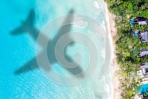 Travel traveling vacation sea symbolic picture airplane flying copyspace copy space Seychelles beach water