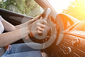 Travel trip car. Happy young woman inside vehicle driving in sunny day. Fun driver ride in summer vacation concept