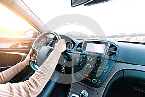 Travel trip car. Happy young woman inside vehicle driving in sunny day. Fun driver ride in winter vacation concept