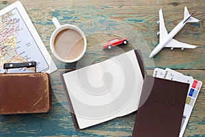 Travel , trip vacation, tourism mockup - close up note book, suitcase, toy airplane and touristic map on wooden table.