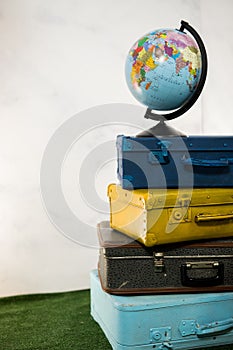 Travel or turism concept. Close up globe on vintage suitcases