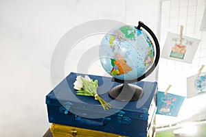 Travel or turism concept. In focus globe on vintage suitcases