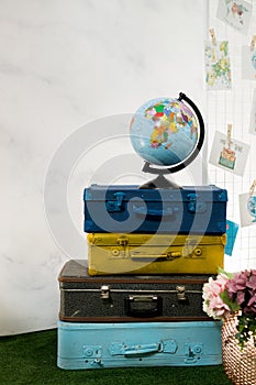 Travel or turism concept. Isolated globe on vintage suitcases