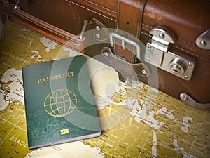 Travel or turism concept. Old suitcase with passport on the wo