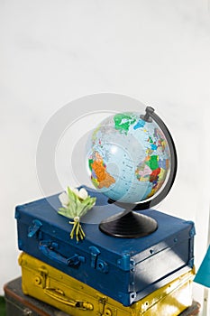 Travel or turism concept. Side view globe on vintage suitcases