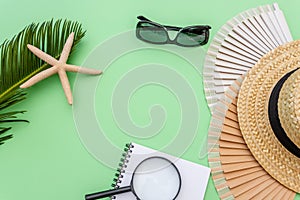 Travel vacation background concept with seashells and photo frames on green table. Top view with copy space. Flat lay