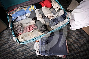 Travel and vacation concept. Packing stuff and a clothes into suitcase. Prepare travel and journey trip