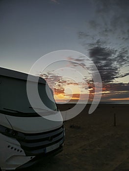 Travel vacation lifestyle with camper parked at the beach with sea view- Recreational vehicle camping car camp in the nature.