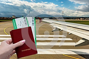 Travel vacation by plane. A female hand holds passports and tickets