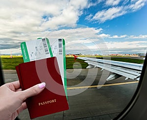 Travel vacation by plane. A female hand holds passports and tickets