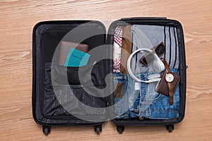 Travel and vacations concept. Open traveler`s bag with clothing,