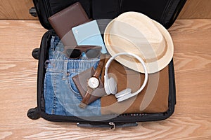 Travel and vacations concept. Open traveler`s bag with clothing,