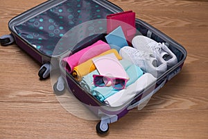 Travel and vacations concept. Open traveler`s bag with clothing,