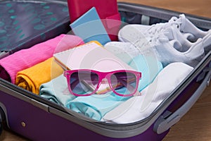 Travel and vacations concept. Open traveler`s bag with clothing,