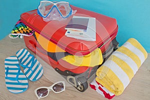 Travel and vacations concept. Open traveler`s bag with clothing, accessories, tickets and passport
