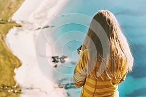 Travel vacations woman tourist standing above ocean