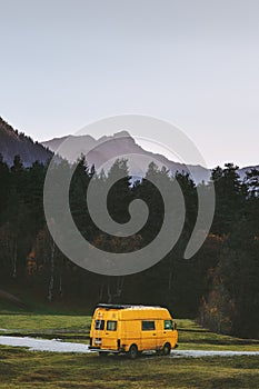 Travel van yellow camper road trip vacations in mountains