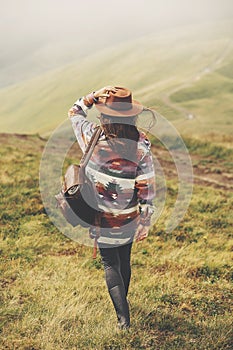 Travel and wanderlust concept. stylish traveler girl holding hat photo