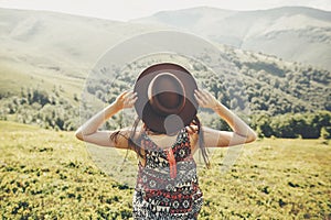 Travel and wanderlust concept. traveler hipster girl holding hat