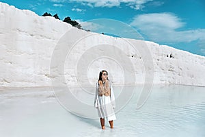 Travel woman enjoying Pamukkale tranvanter pools at ancient Hierapolis , Denizli