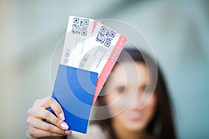 Travel. Woman holding two air ticket in abroad passport near airport