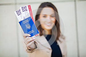 Travel. Woman holding two air ticket in abroad passport near airport