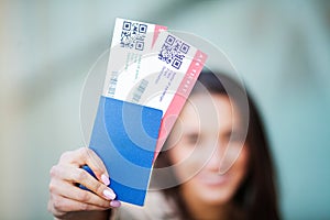 Travel. Woman holding two air ticket in abroad passport near airport