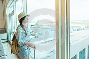 Travel woman looking at window in airport