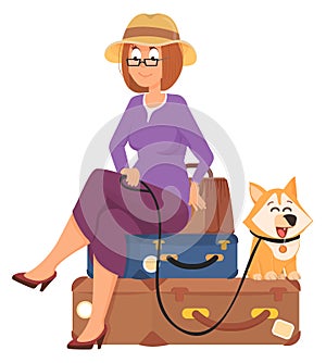 Travel woman wait sitting on lugagge with cute dog photo
