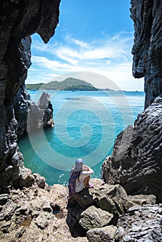 Travel women in a cave near the sea in Keo Sichang,