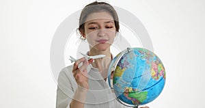 Travel world by plane. Pretty girl holding an airplane and world map globe