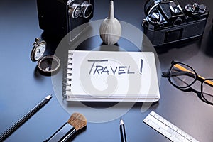 Travel is written on small notepad with a pencils