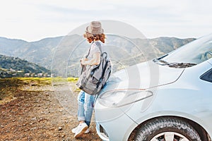 Travel - young beautiful hipster woman in hat travel by car, rent a car in vacations