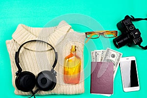 Traveler accessories on green background. Flat lay