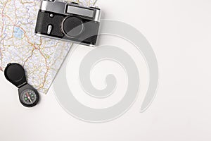 Traveler accessories. Map with old vintage camera and compas isolated on white background with empty space for text