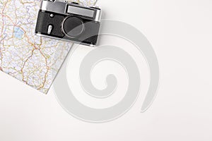 Traveler accessories. Map with old vintage camera isolated on white background with empty space