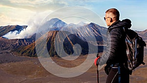 Traveler against fantastic sunrise on the Bromo volcano. Indonesia. Java islan